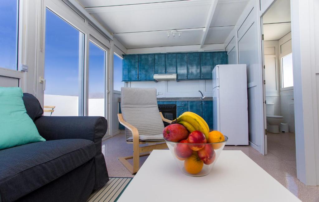 a bowl of fruit on a table in a living room at Arinaga Colors, tu casa en la playa in Arinaga