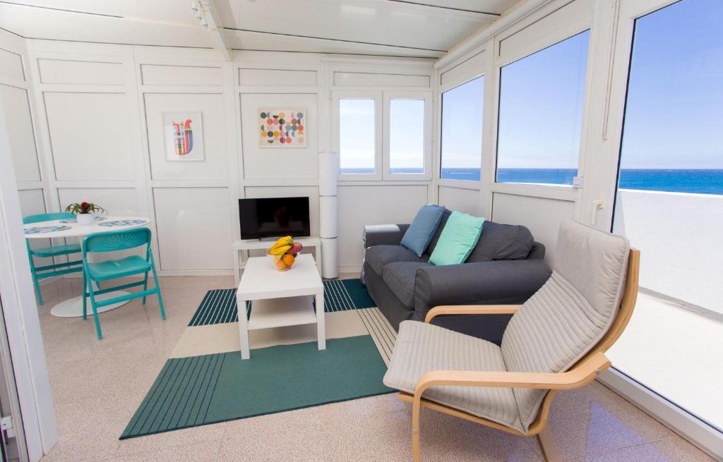 a living room with a couch and a table at Arinaga Colors, tu casa en la playa in Arinaga