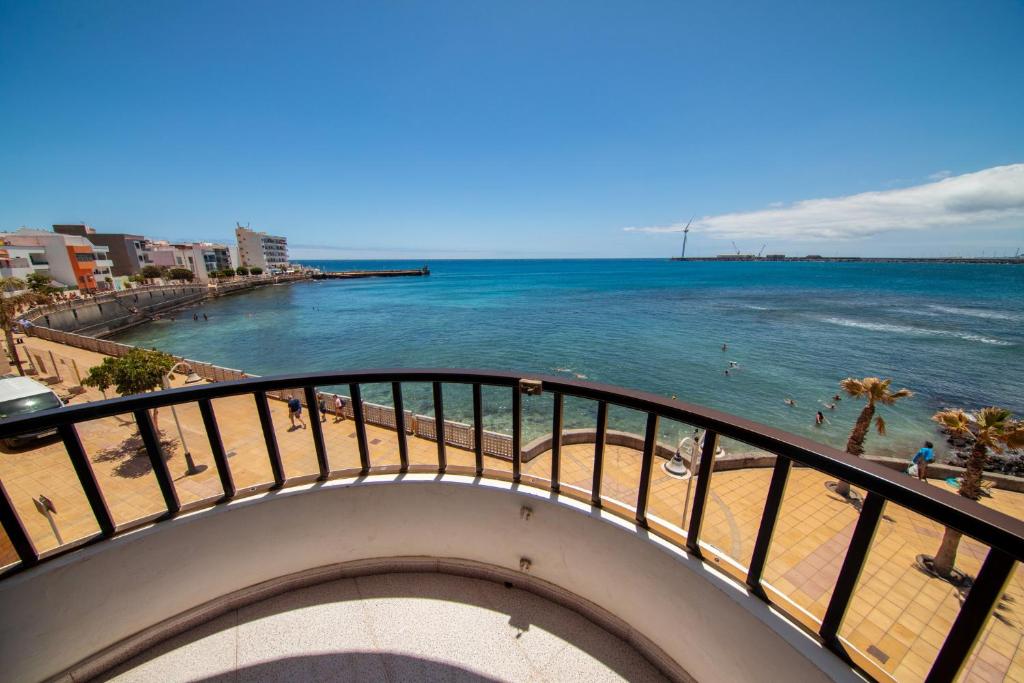 a view of the ocean from a balcony of a beach at Arinaga Colors, tu casa en la playa in Arinaga