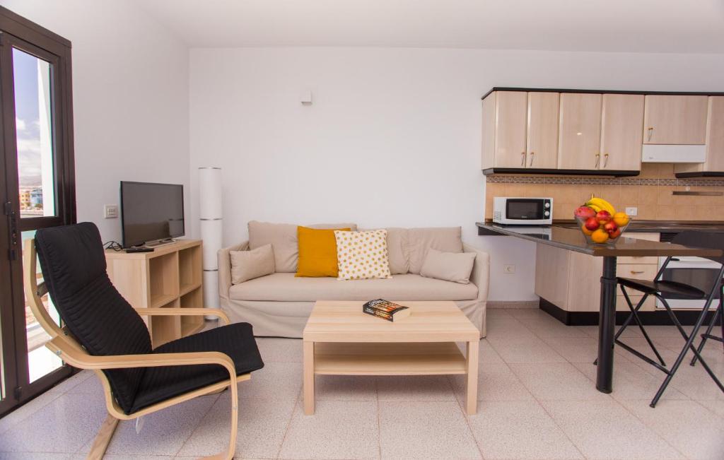 a living room with a couch and a table at Arinaga Colors, tu casa en la playa in Arinaga