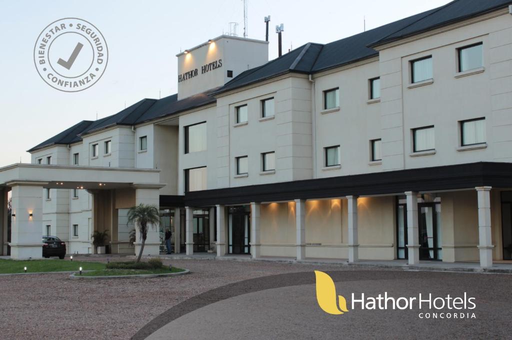 a hotel with a building with a sign in front of it at Hathor Concordia in Concordia