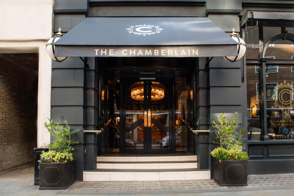 a store front with a door open with a large window at The Chamberlain in London