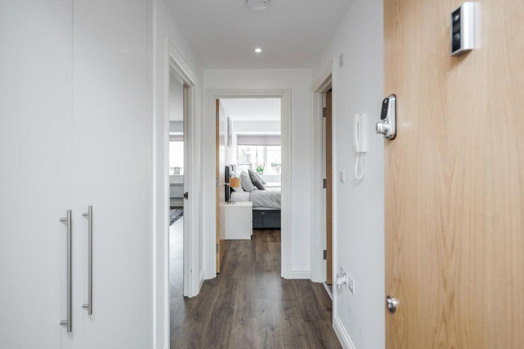 a hallway leading to a living room with a bed at Watford Central Serviced Apartments - F5 in Watford