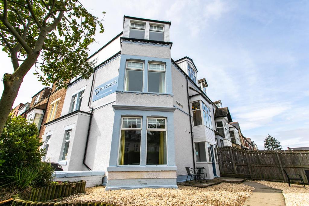 a white building with a tower on top of it at Stay Coastal in Whitley Bay