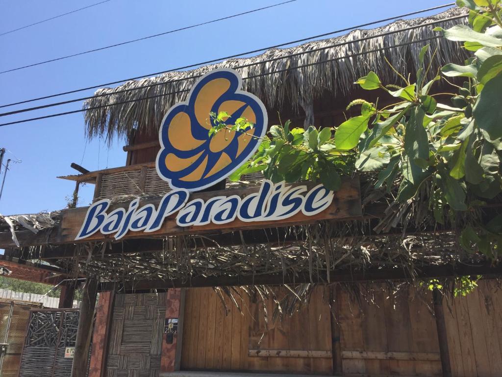 a sign for a bbq paradise on a building at Pension Baja Paradise in La Paz