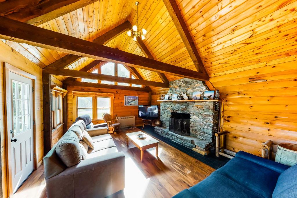 a living room with a couch and a fireplace at Lake Eden Escape in Eden
