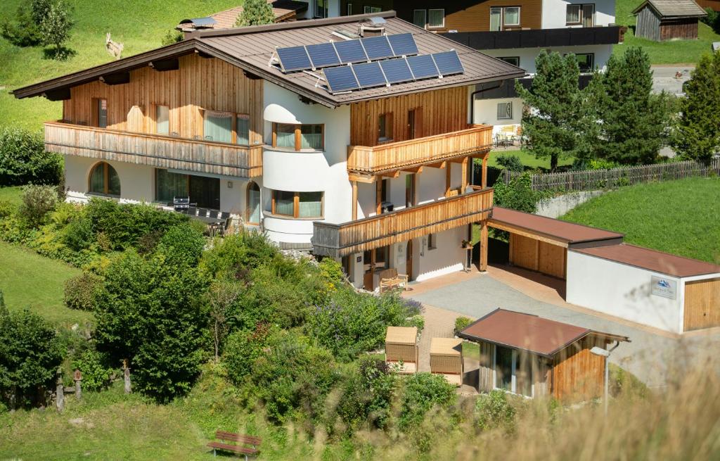 an aerial view of a house with solar panels on the roof at Alpchalet Tirol in Berwang