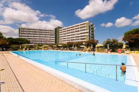 a large swimming pool in front of a large building at Jet Residence Agenzia Riviera del Conero in Porto Recanati