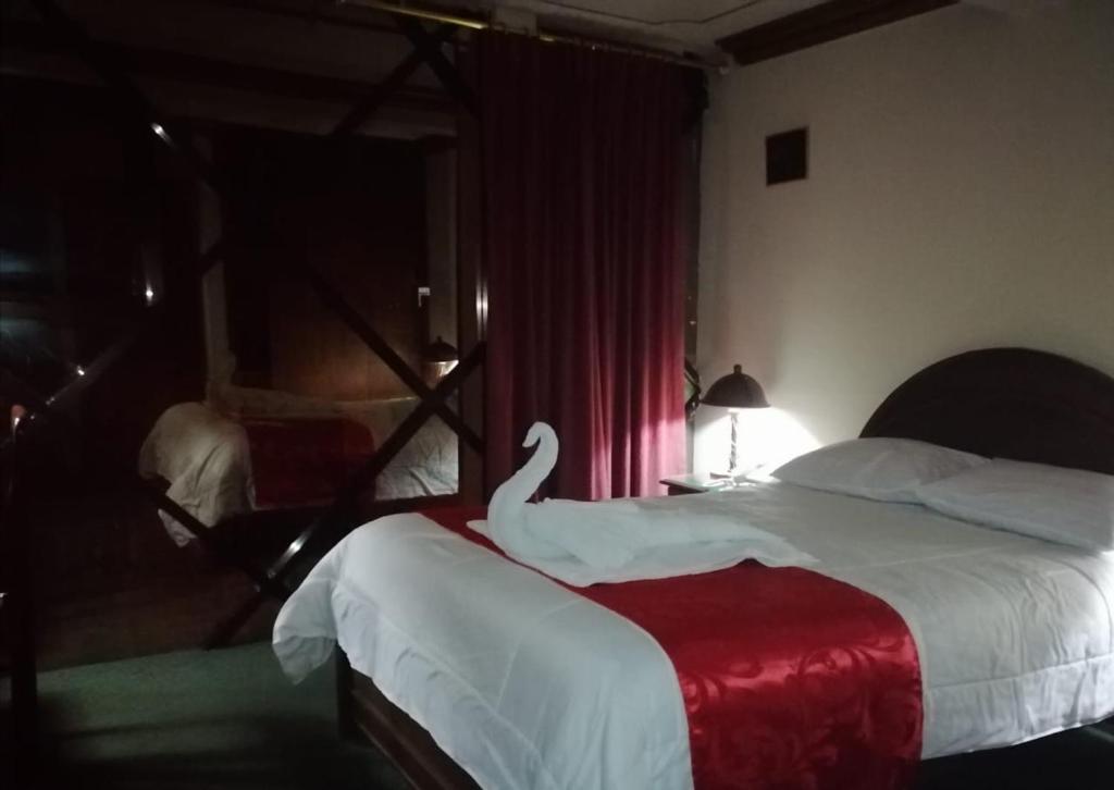 Postel nebo postele na pokoji v ubytování Hotel Alexander