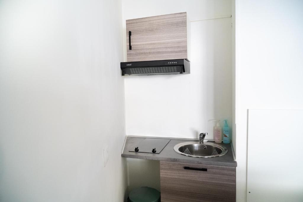 a small kitchen with a sink and a counter at 5 minutes Saint Charles in Marseille