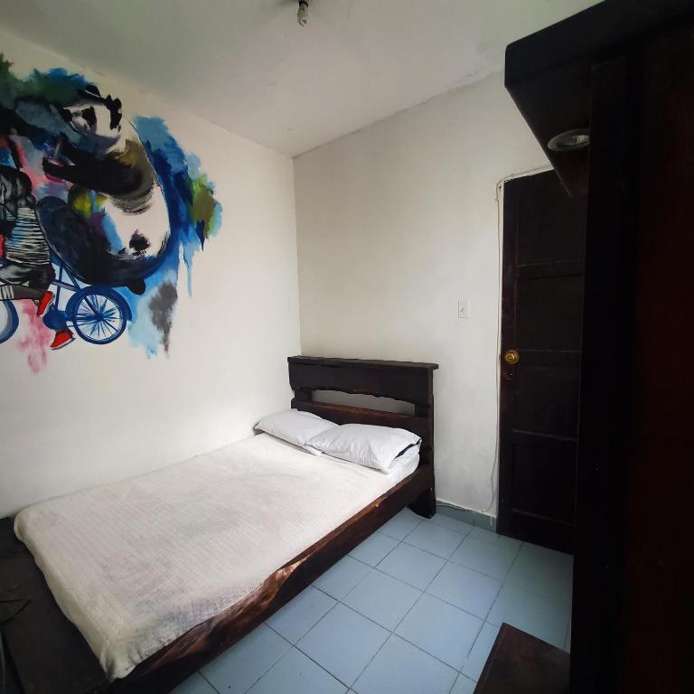 Postel nebo postele na pokoji v ubytování Hostal CQ Chapinero