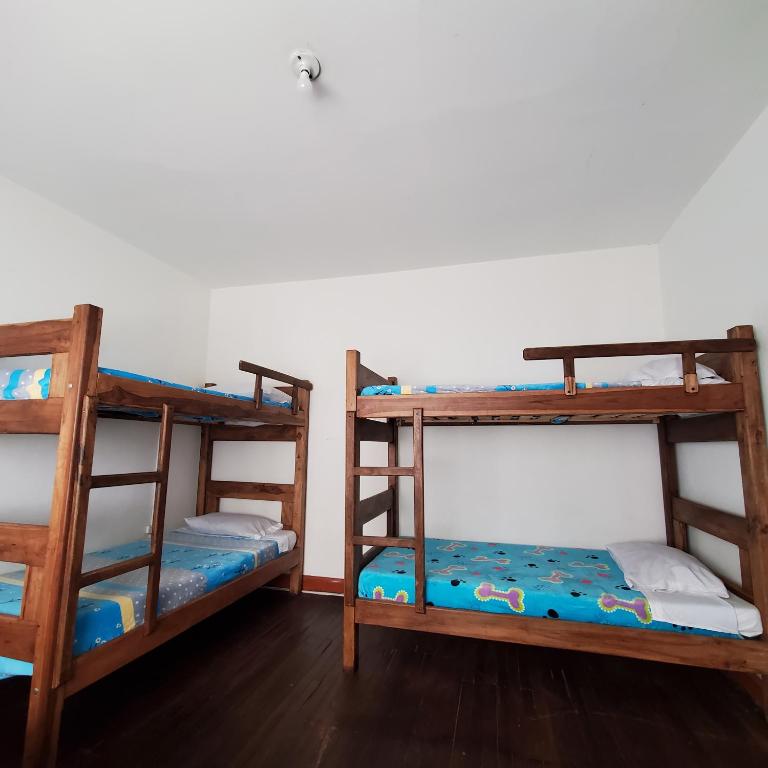 Postel nebo postele na pokoji v ubytování Hostal CQ Chapinero