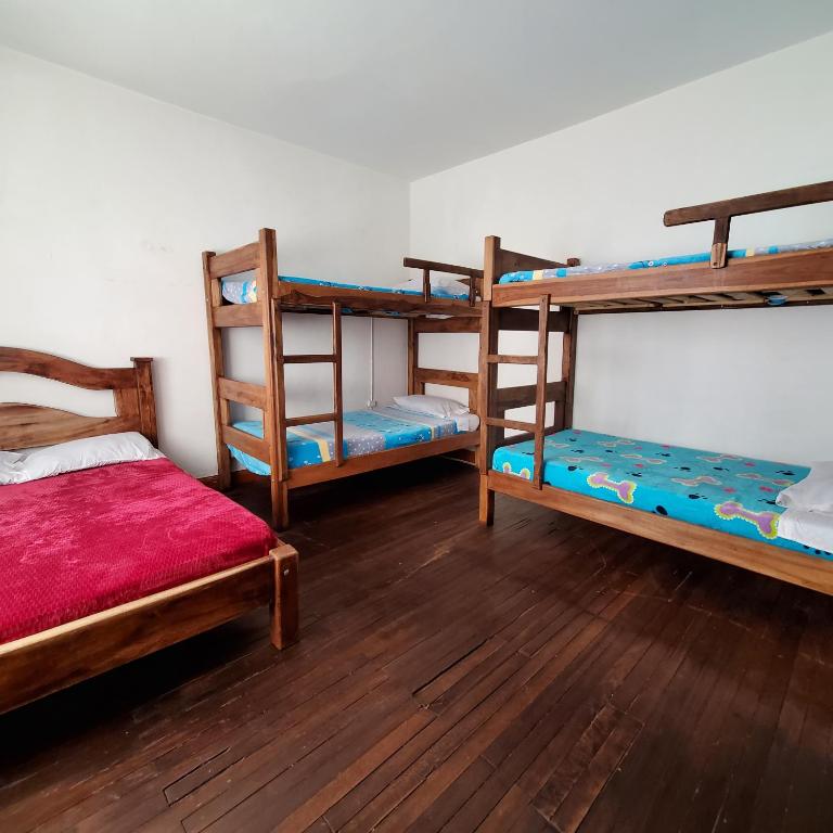 Postel nebo postele na pokoji v ubytování Hostal CQ Chapinero