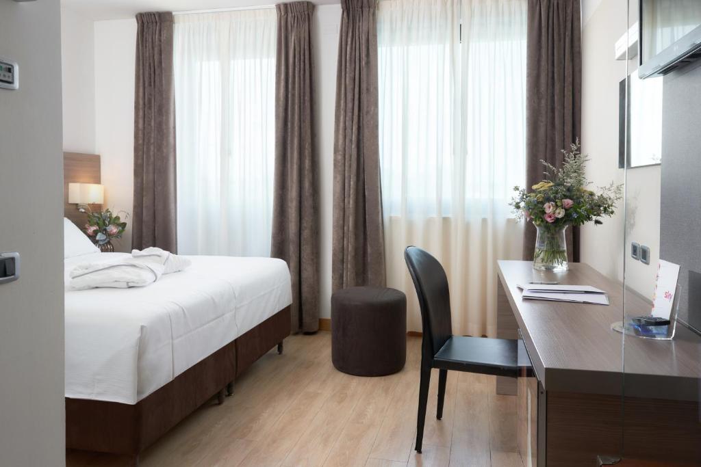 Postel nebo postele na pokoji v ubytování Hotel Omnia