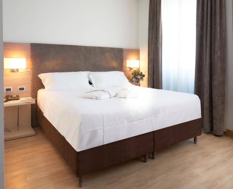 Postel nebo postele na pokoji v ubytování Hotel Omnia