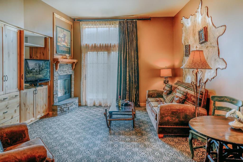 a living room with a couch and a table at Big Sky Resort Village Center in Big Sky