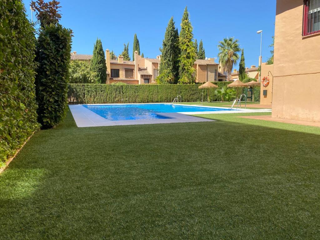 a swimming pool in the yard of a house at Apartamento Almunia in Granada