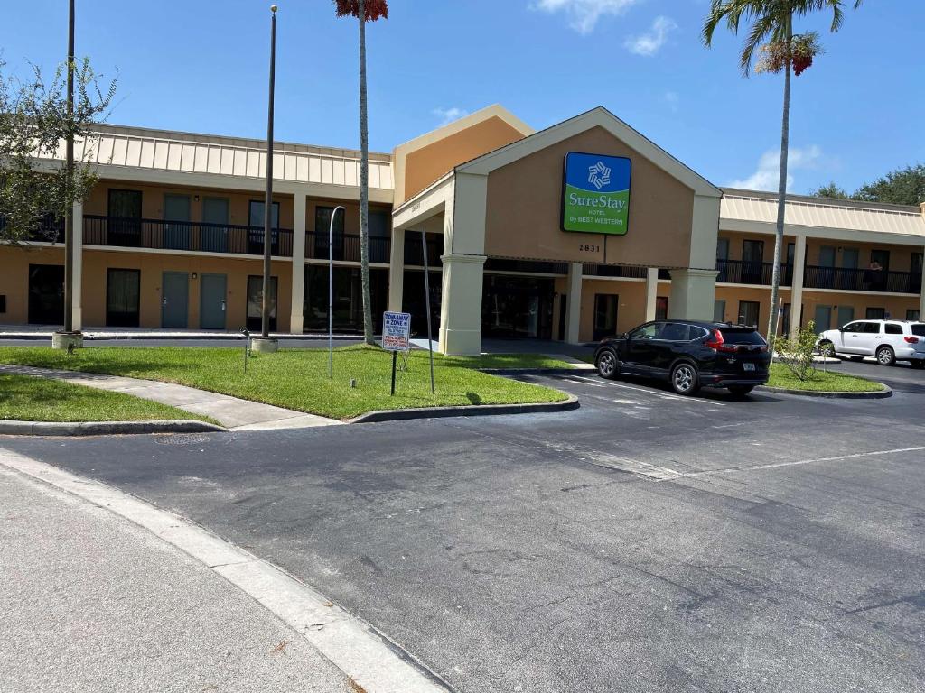 a parking lot in front of a hospital at SureStay Hotel by Best Western Fort Pierce in Fort Pierce