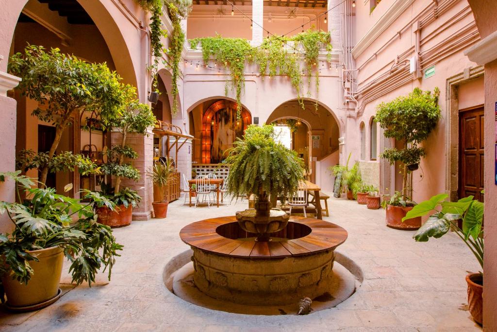 
a large ornate building with a fountain in the middle of it at Selina San Miguel de Allende in San Miguel de Allende
