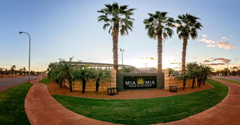 a park with palm trees in front of a sign at Mia Mia House in the Desert in Newman