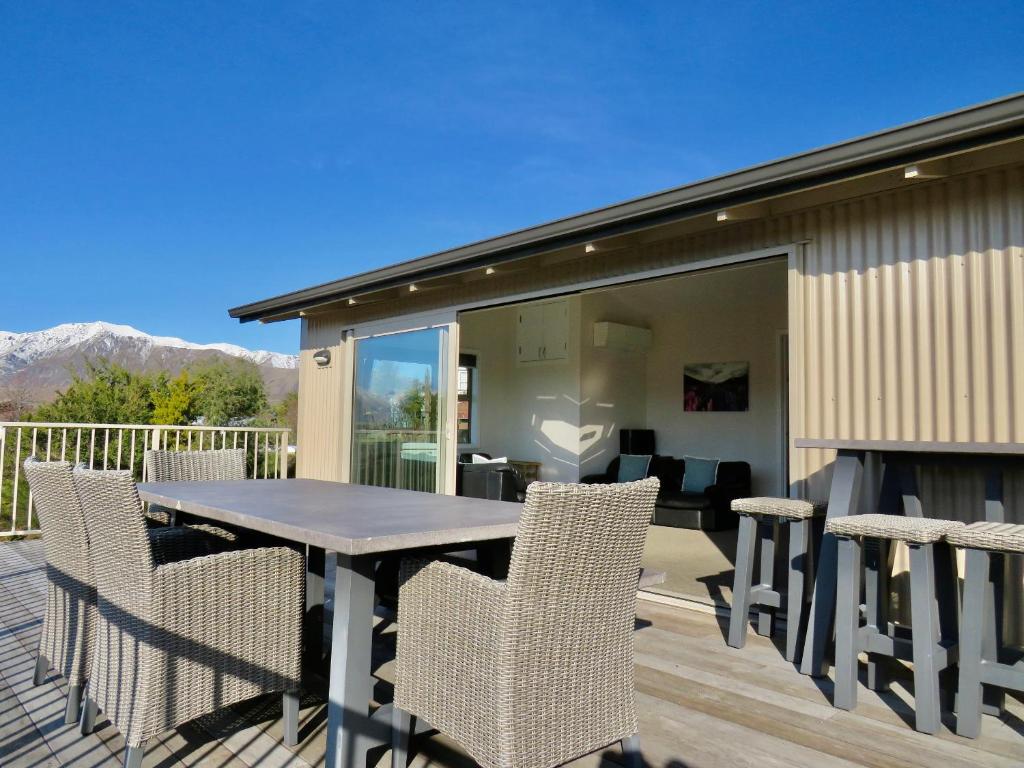 a patio with a table and chairs on a deck at Korokipo - Lake Tekapo in Lake Tekapo