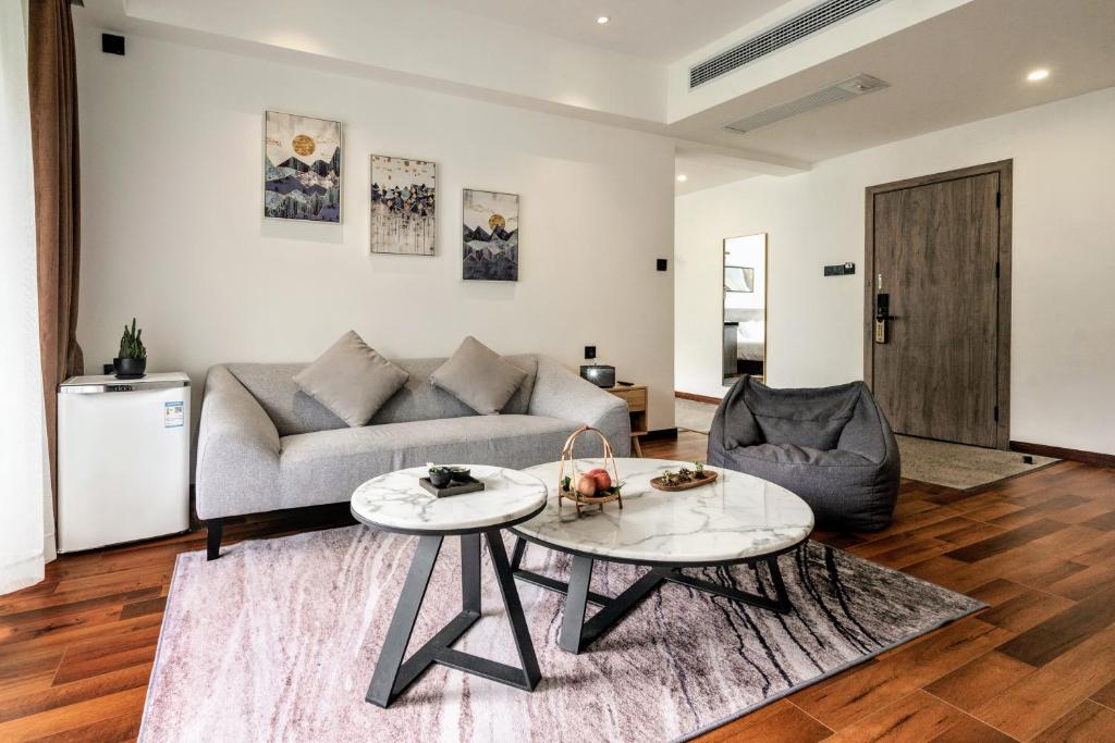 a living room with a couch and a table at Whispering Mountains Boutique Hotel in Zhangjiajie
