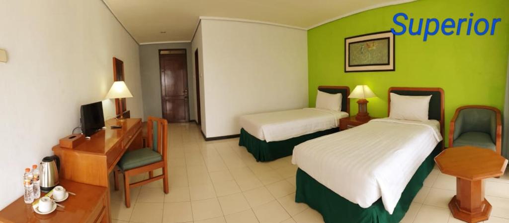 Postel nebo postele na pokoji v ubytování Grand Whiz Hotel Bromo