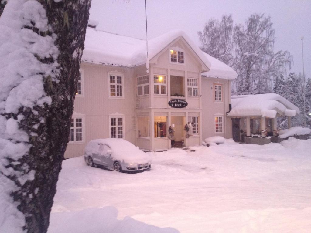 Eggedal的住宿－艾格多伯格爾斯杜酒店，雪中停放汽车的房子