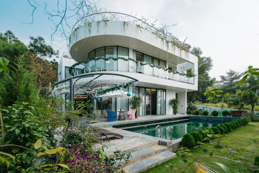 een huis met een zwembad ervoor bij *BOM HOMES* FLAMINGO ĐAI LAI RESORT in Ngọc Quang