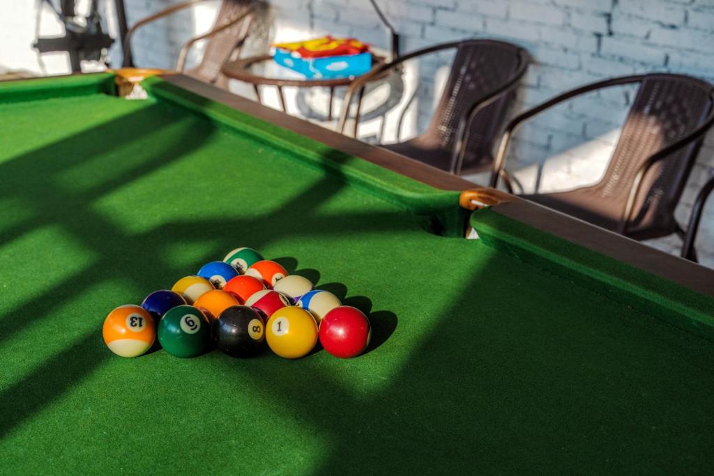 a pile of balls on top of a pool table at Whispering Mountains Boutique Hotel in Zhangjiajie