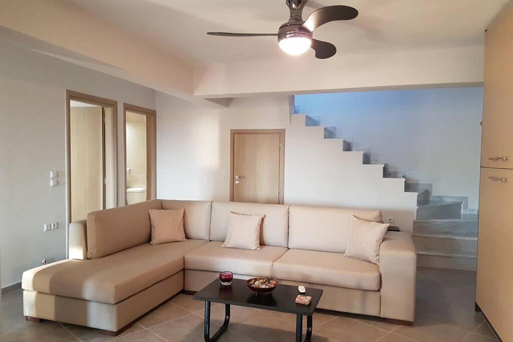 a living room with a couch and a staircase at Galaxidi Family House in Galaxidhion