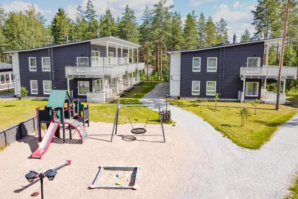 a house with a playground in front of it at Saimaa Life Apartments in Imatra