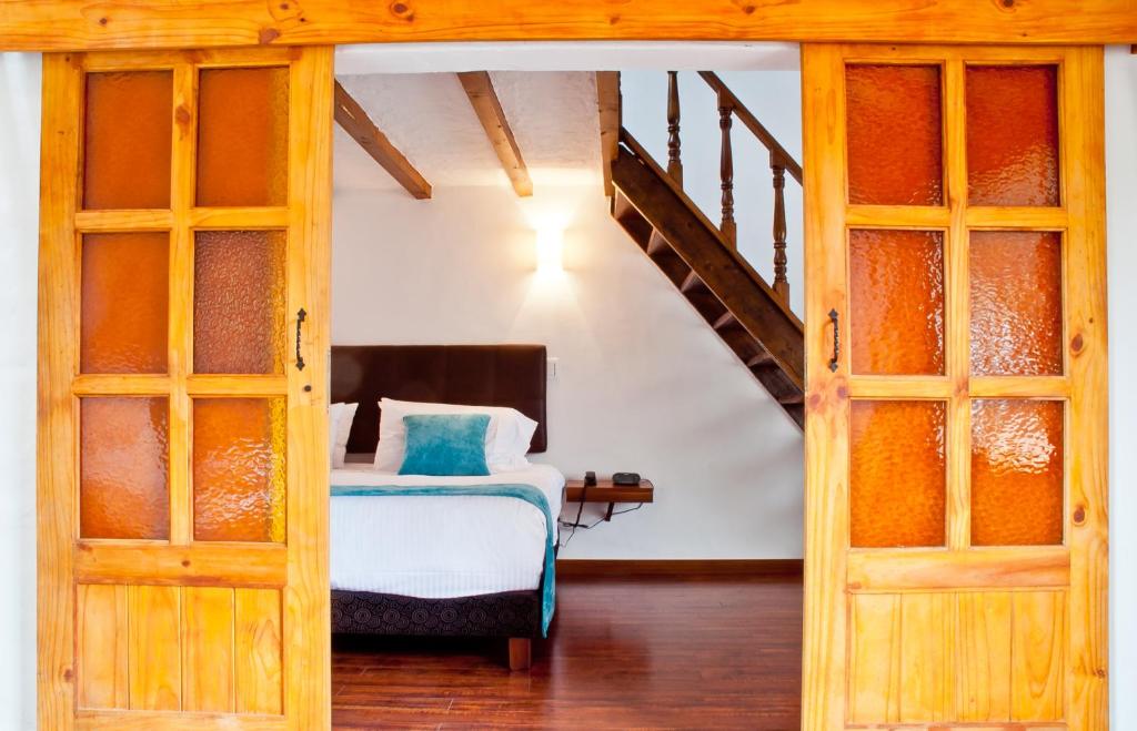 Postel nebo postele na pokoji v ubytování Hotel Casona Usaquen