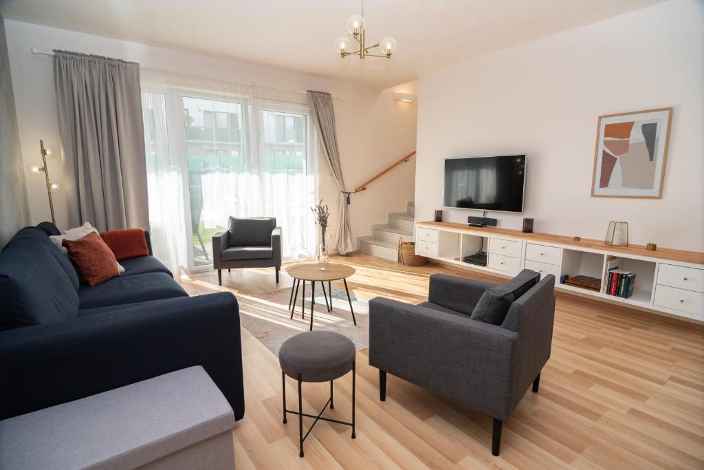 a living room with a couch and a tv at 3 bed modern family house in Mikulov in Mikulov