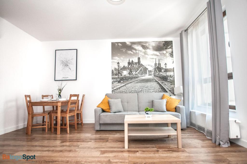 a living room with a couch and a table at BatogoSpot Towers in Wrocław