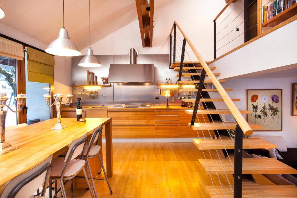a kitchen with a spiral staircase and a dining room at L'appart du chateau des Girards in Lans-en-Vercors
