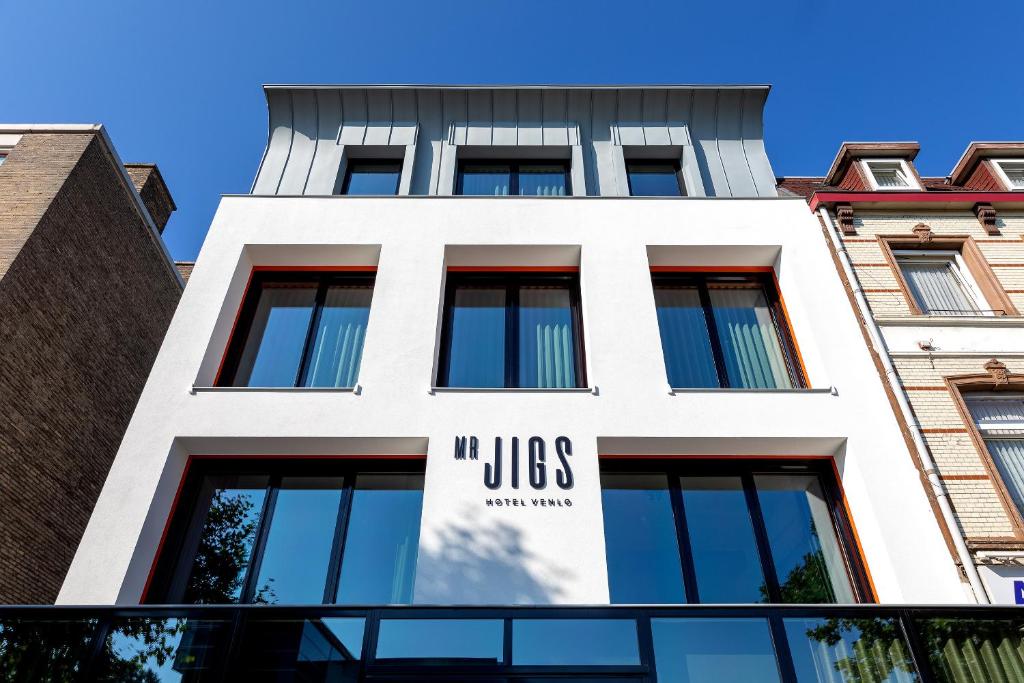 a building with a sign on the side of it at Mr Jigs in Venlo