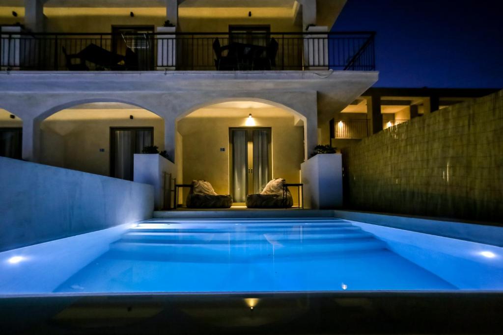 a swimming pool in a house at night at Agave Boutique Hotel in Laganas