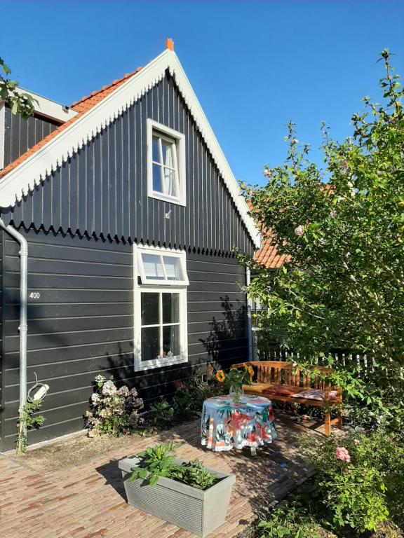 a black house with a bench in front of it at B & B Tulp Amsterdam Noord in Amsterdam