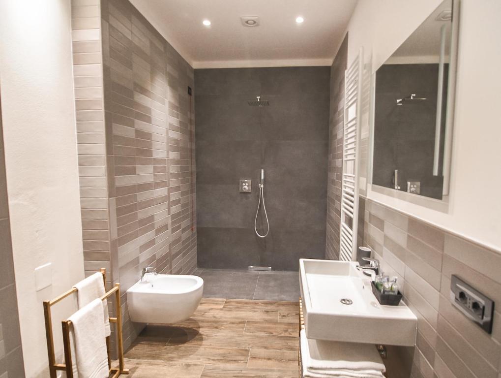 a bathroom with a sink and a toilet and a shower at Locanda Il Carugio in Corniglia