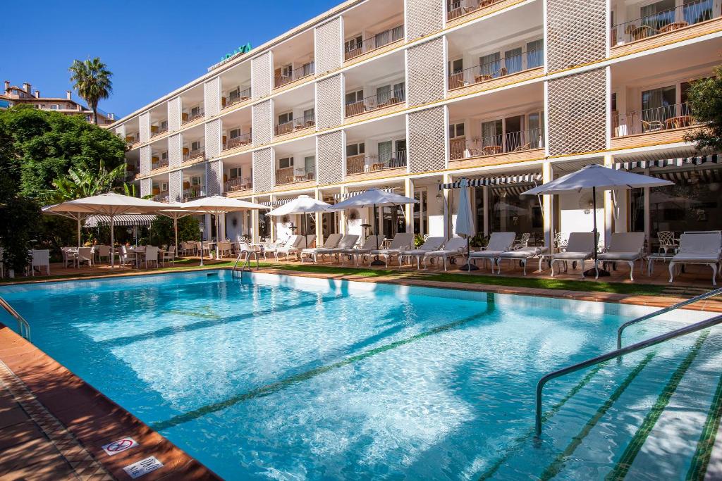 a large swimming pool in front of a hotel at Hotel Araxa - Adults Only in Palma de Mallorca