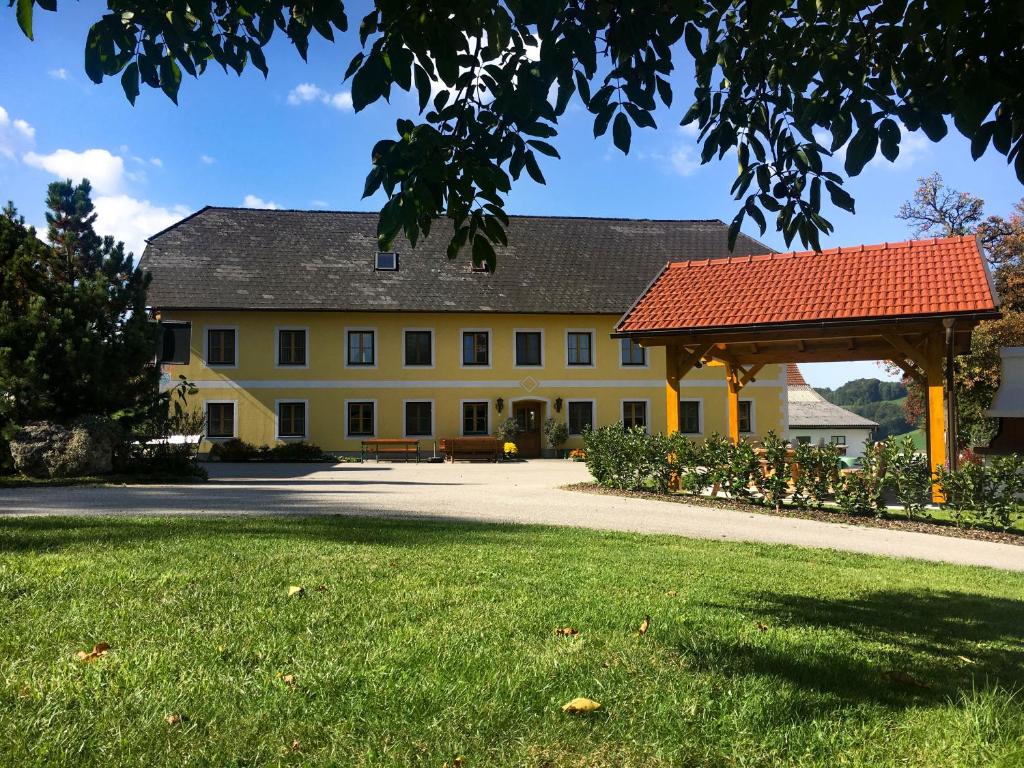 a large yellow building with a red roof at Familienbauernhof Salmanner in Steinbach an der Steyr
