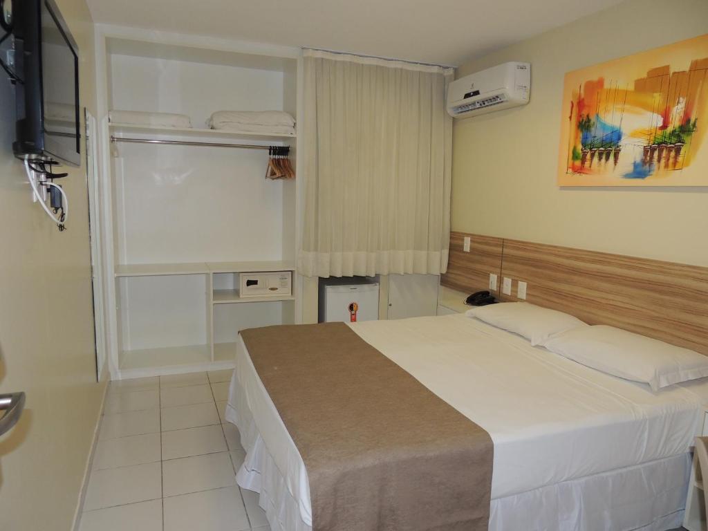 Postel nebo postele na pokoji v ubytování Hotel Três Caravelas