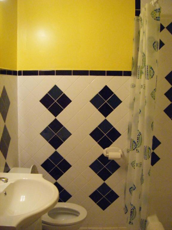 a bathroom with a white toilet and a sink at Auberge des Arts Bed and Breakfast in Ottawa