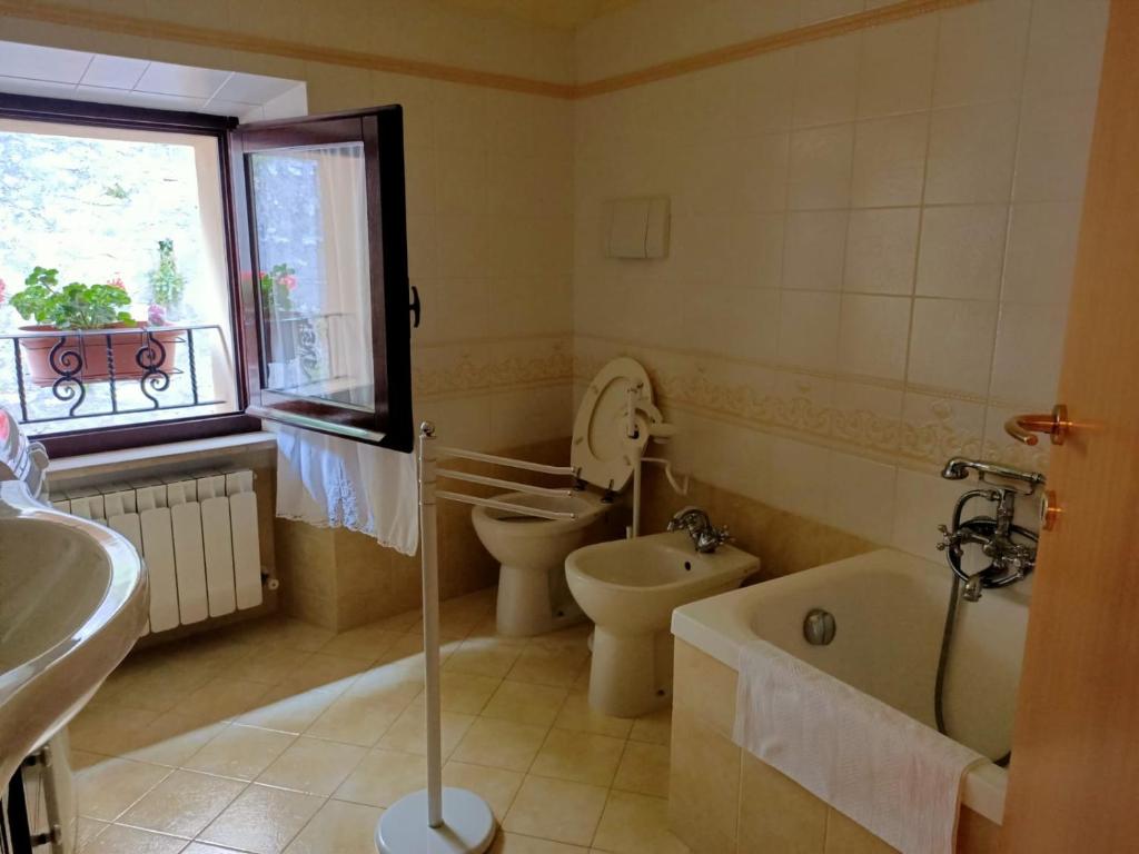 a bathroom with a tub and a toilet and a sink at B&B Brunamonti in Arcevia