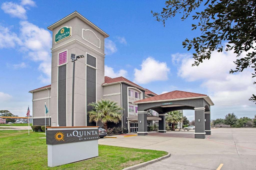 a hotel with a clock tower in front of a building at La Quinta by Wyndham Fairfield TX in Fairfield