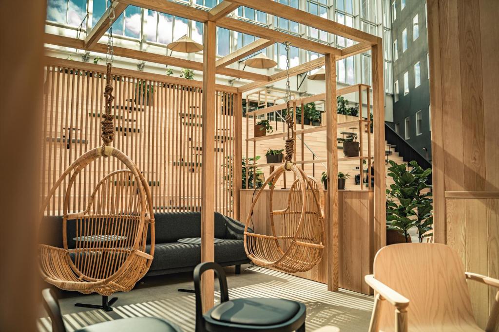 a room with chairs and swings in a building at VALO Hotel & Work Helsinki in Helsinki