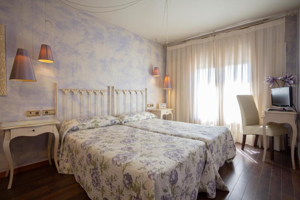 Postel nebo postele na pokoji v ubytování Hostal Los Canteros