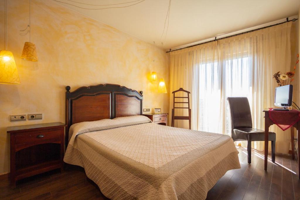 Postel nebo postele na pokoji v ubytování Hostal Los Canteros