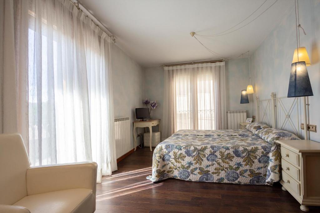 Postel nebo postele na pokoji v ubytování Hostal Los Canteros